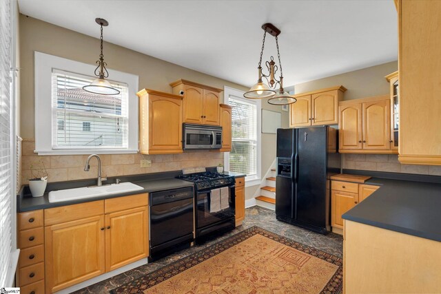 kitchen with tasteful backsplash, decorative light fixtures, black appliances, an inviting chandelier, and sink