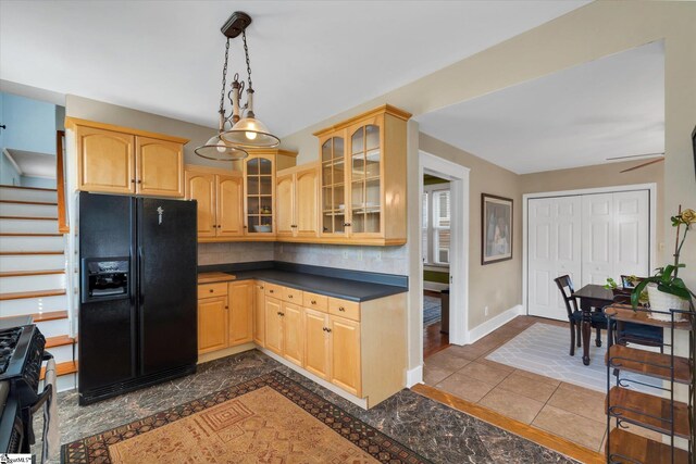 kitchen featuring light brown cabinetry, tile patterned floors, ceiling fan, black appliances, and pendant lighting