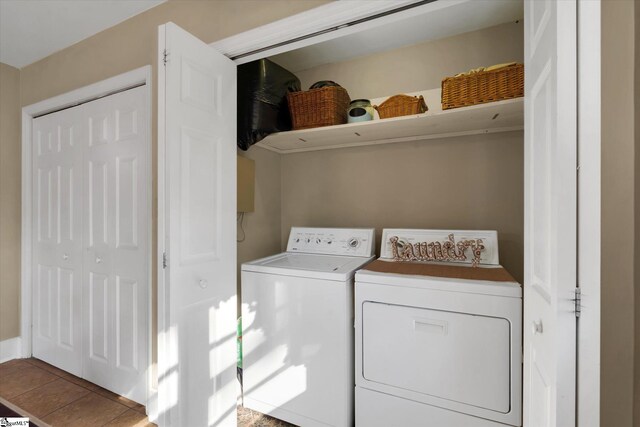 clothes washing area with washing machine and clothes dryer and tile patterned floors