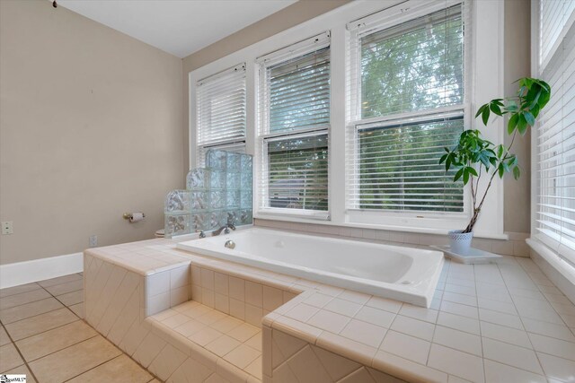 bathroom featuring a relaxing tiled tub and tile patterned floors