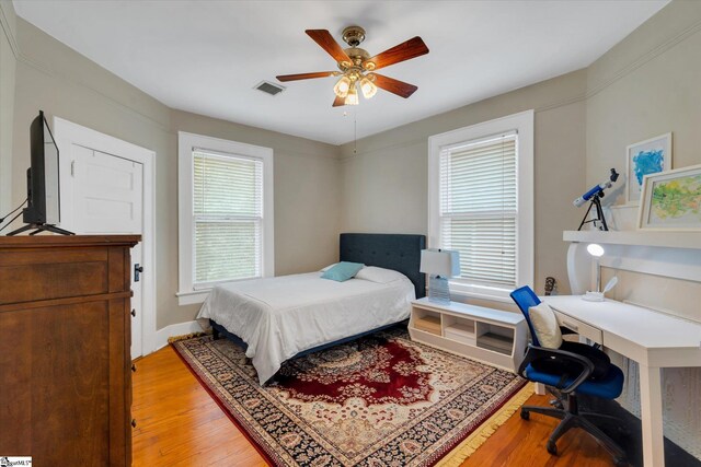 bedroom with light hardwood / wood-style flooring and ceiling fan