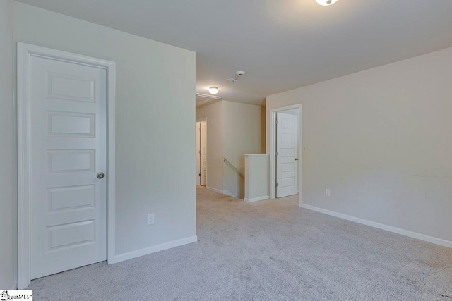 unfurnished room with light colored carpet