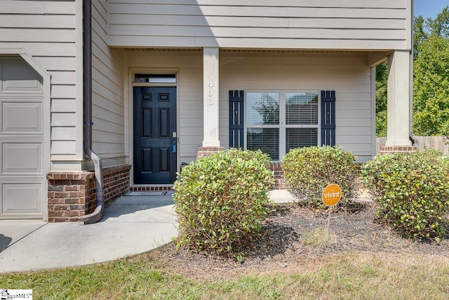 view of exterior entry featuring a porch