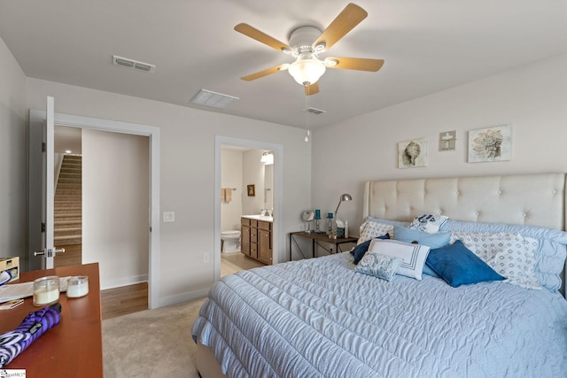 bedroom featuring light colored carpet, connected bathroom, and ceiling fan