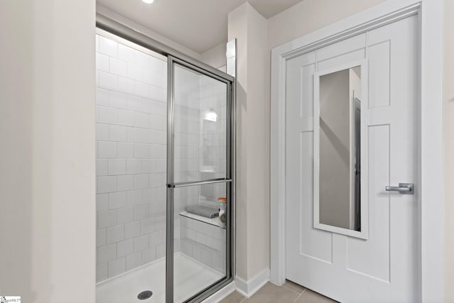 bathroom with tile patterned floors and walk in shower