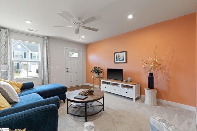 carpeted living room featuring ceiling fan