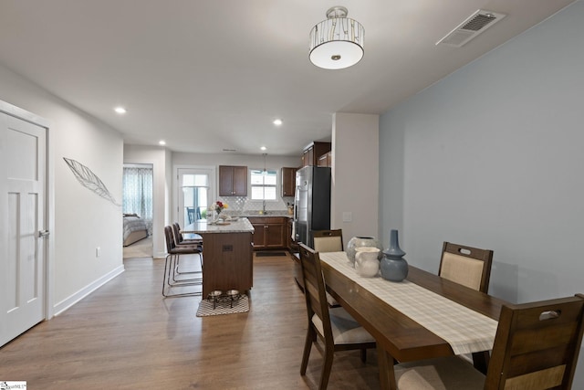 dining space featuring hardwood / wood-style flooring and sink