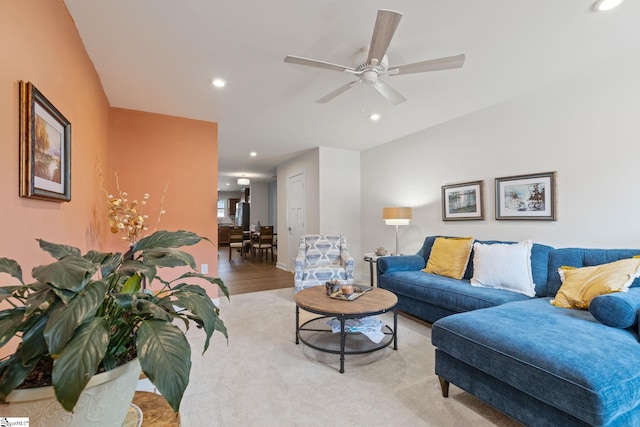 living room featuring light wood-type flooring and ceiling fan