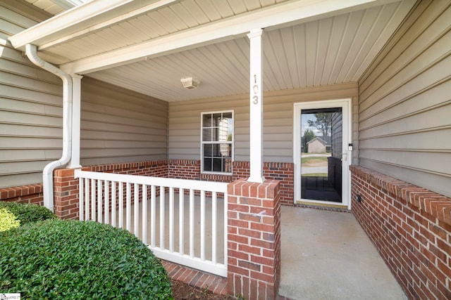 view of exterior entry with a porch