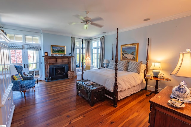 bedroom with french doors, ornamental molding, ceiling fan, and dark wood-type flooring