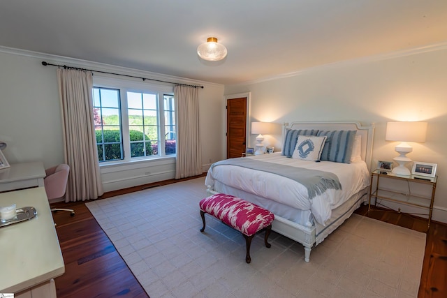 bedroom featuring hardwood / wood-style floors and crown molding