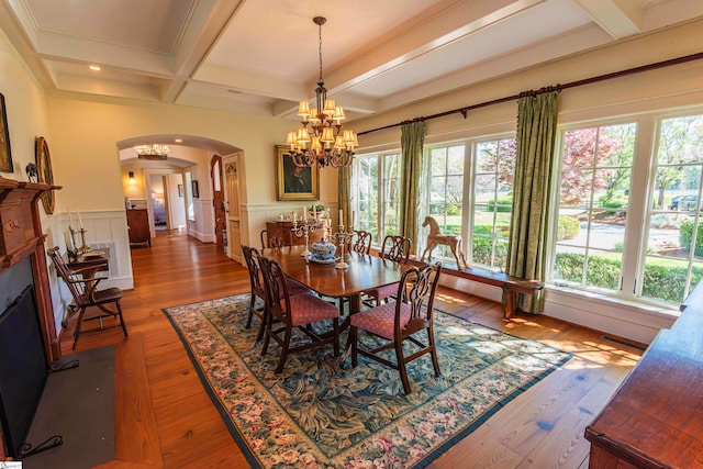 dining space with beamed ceiling, plenty of natural light, wood-type flooring, and coffered ceiling