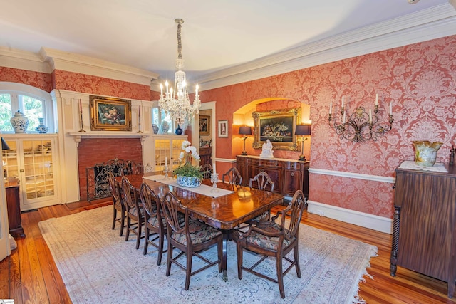 571 E Main St, Spartanburg, SC 29302 - dining area featuring a chandelier, wallpapered walls, wood finished floors, ornamental molding, and baseboards