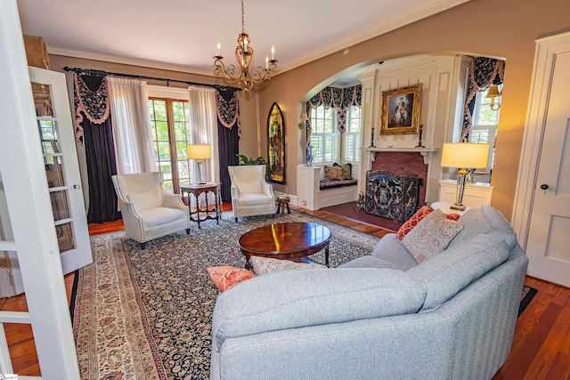 571 E Main St, Spartanburg, SC 29302 - living area with arched walkways, wood finished floors, plenty of natural light, a chandelier, and ornamental molding