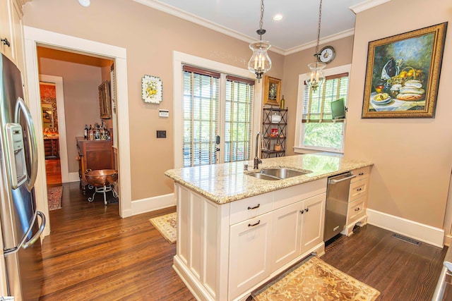 kitchen with stainless steel appliances, white cabinetry, sink, light stone counters, and dark wood-type flooring