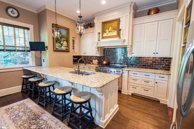 kitchen featuring stainless steel appliances, light stone countertops, dark hardwood / wood-style floors, and sink