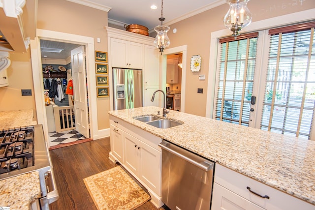 kitchen featuring ornamental molding, appliances with stainless steel finishes, dark wood-type flooring, and hanging light fixtures