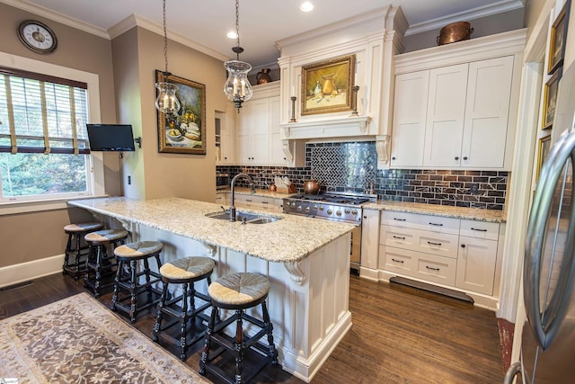 571 E Main St, Spartanburg, SC 29302 - kitchen with appliances with stainless steel finishes, a sink, dark wood-style flooring, decorative backsplash, and baseboards