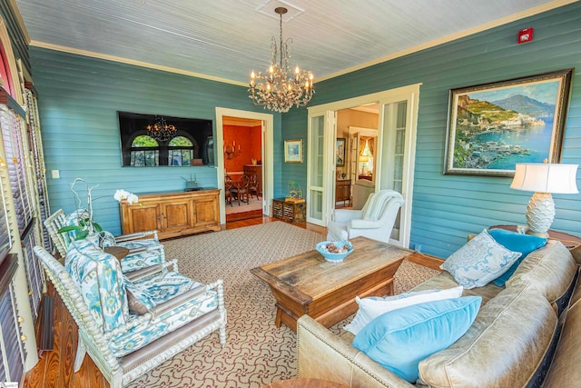 living room with a chandelier and ornamental molding