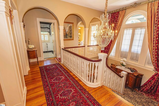 571 E Main St, Spartanburg, SC 29302 - hall with a chandelier, wood finished floors, healthy amount of natural light, and arched walkways