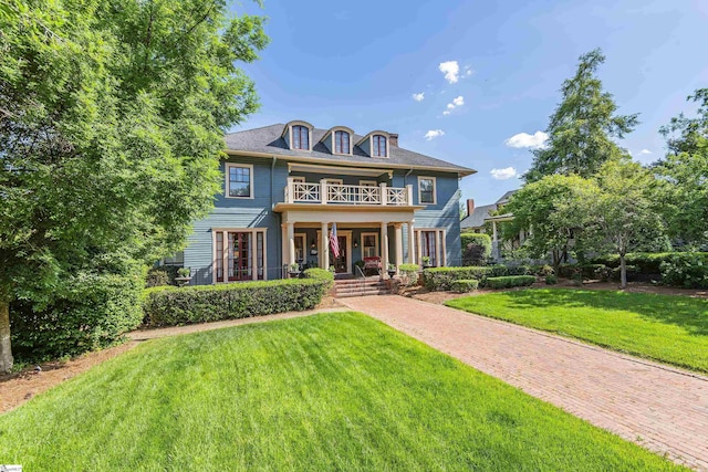 571 E Main St, Spartanburg, SC 29302 - georgian-style home with a balcony, a front yard, and covered porch