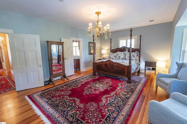 571 E Main St, Spartanburg, SC 29302 - bedroom featuring a chandelier and wood finished floors