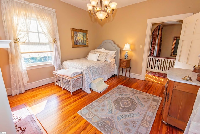 bedroom featuring hardwood / wood-style floors and an inviting chandelier