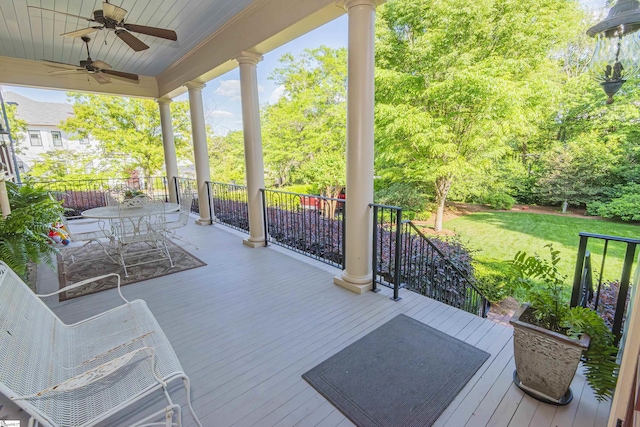 571 E Main St, Spartanburg, SC 29302 - wooden terrace featuring a ceiling fan, outdoor dining area, a yard, and view of wooded area