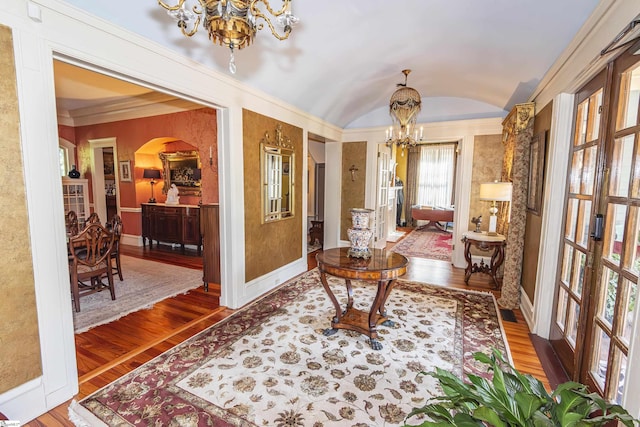 571 E Main St, Spartanburg, SC 29302 - living area with a chandelier, arched walkways, wood finished floors, baseboards, and lofted ceiling