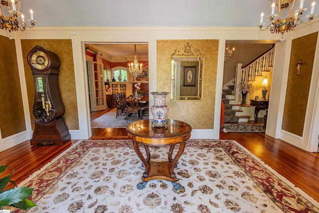 571 E Main St, Spartanburg, SC 29302 - foyer entrance featuring a chandelier, wood finished floors, ornamental molding, stairs, and baseboards