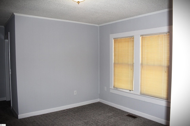 unfurnished room featuring ornamental molding, a textured ceiling, and dark carpet