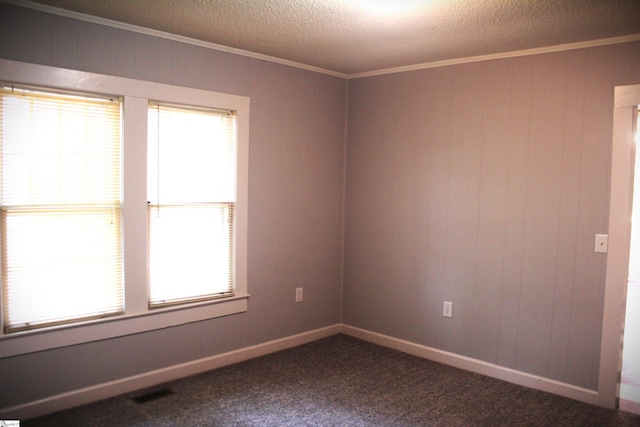 carpeted empty room with a textured ceiling