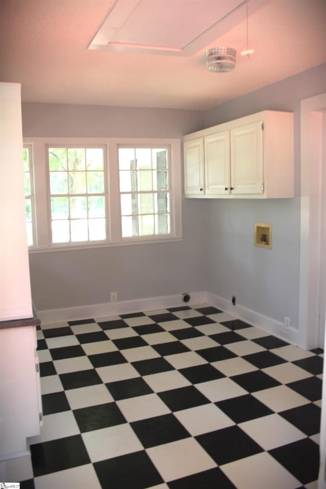 interior space featuring hookup for a washing machine, cabinets, and electric dryer hookup