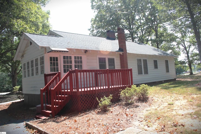 rear view of house with a wooden deck