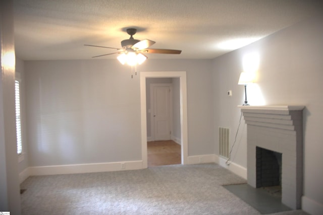 unfurnished living room with a healthy amount of sunlight, ceiling fan, light carpet, and a brick fireplace