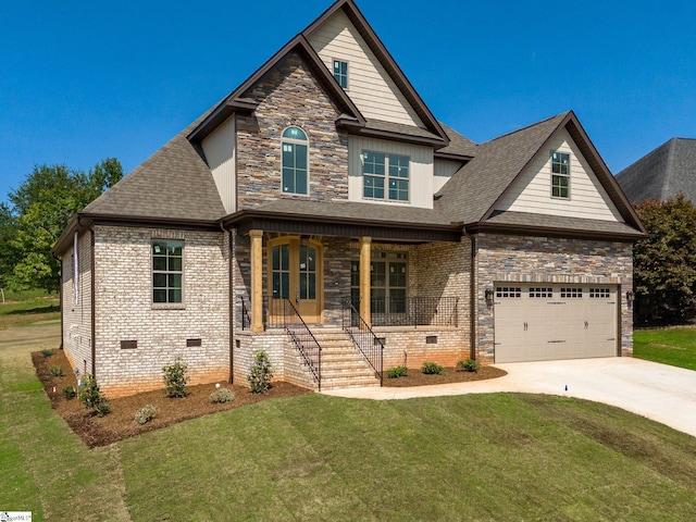 view of front of home featuring a front yard, covered porch, and a garage