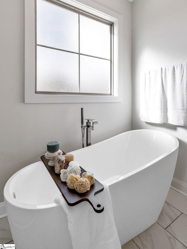 bathroom with a bath and a healthy amount of sunlight