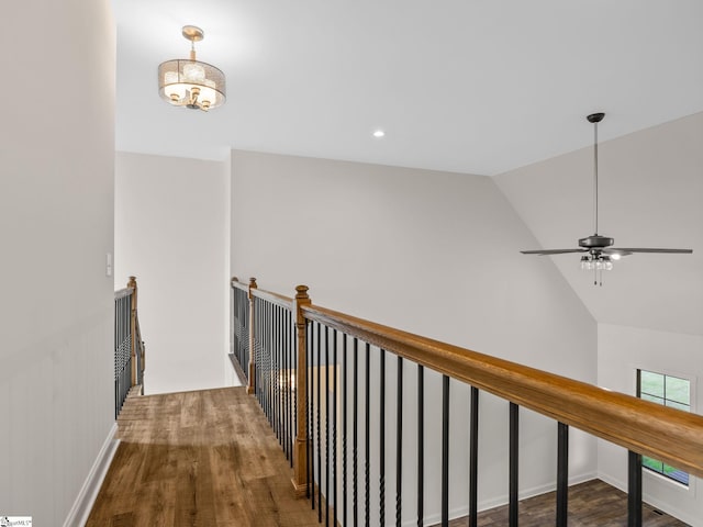 hallway with lofted ceiling and wood-type flooring