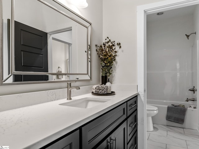 full bathroom with vanity, washtub / shower combination, and toilet