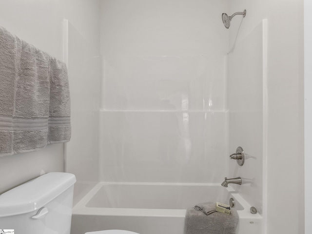 bathroom featuring toilet and shower / bathing tub combination