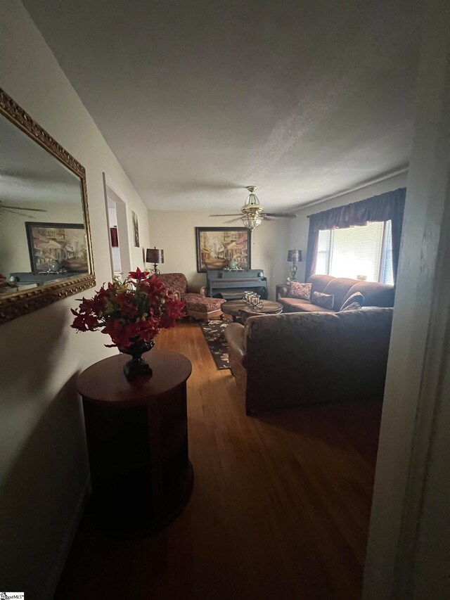 living room featuring hardwood / wood-style flooring and ceiling fan