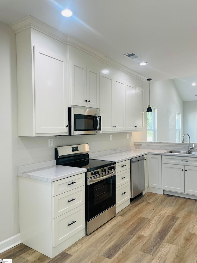 kitchen featuring light wood-type flooring, white cabinetry, sink, and stainless steel appliances