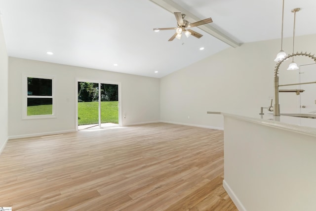 unfurnished living room with baseboards, vaulted ceiling with beams, recessed lighting, ceiling fan, and light wood-style floors