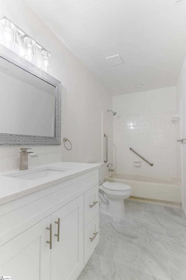 full bath with toilet, marble finish floor, shower / washtub combination, and vanity