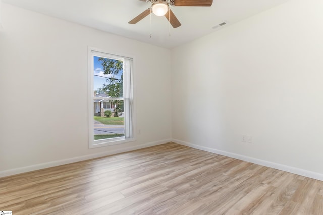 empty room featuring ceiling fan, visible vents, baseboards, and light wood-style flooring