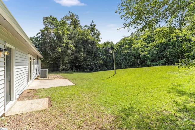 view of yard featuring central air condition unit, a patio, and fence