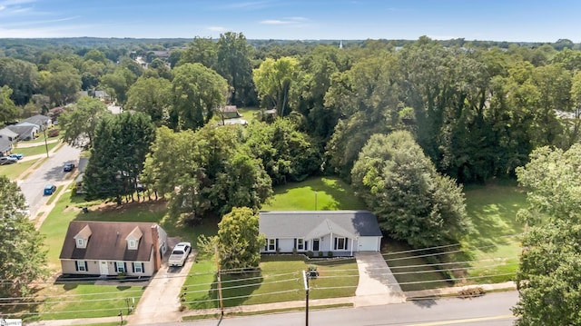 birds eye view of property with a view of trees