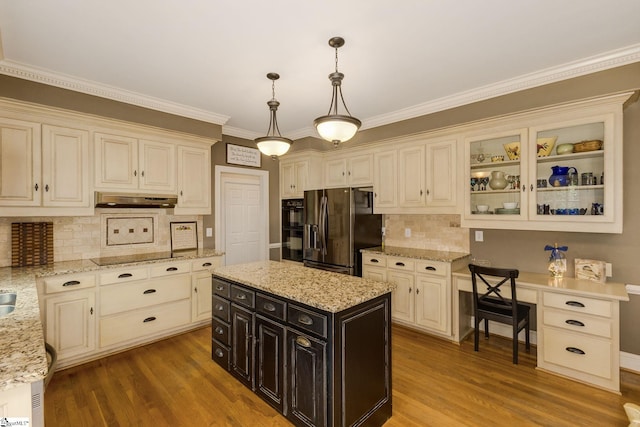 kitchen with range hood, hanging light fixtures, hardwood / wood-style flooring, a center island, and black appliances