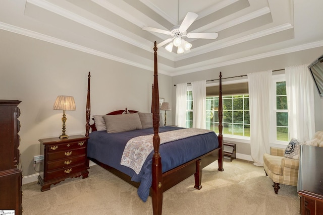 bedroom featuring ceiling fan, light colored carpet, a raised ceiling, and crown molding