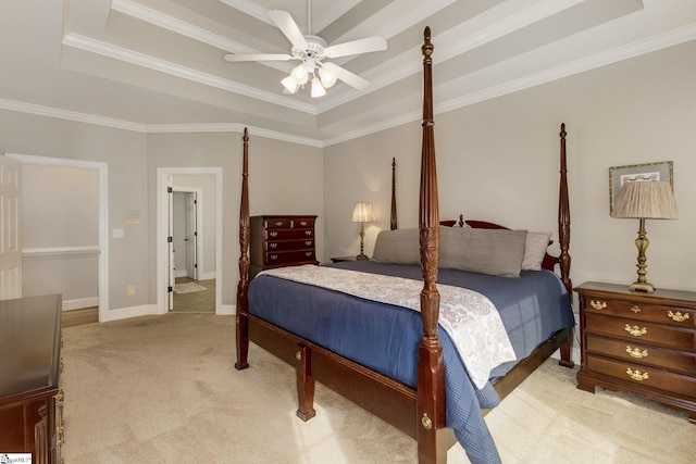 carpeted bedroom with ceiling fan, a raised ceiling, and crown molding